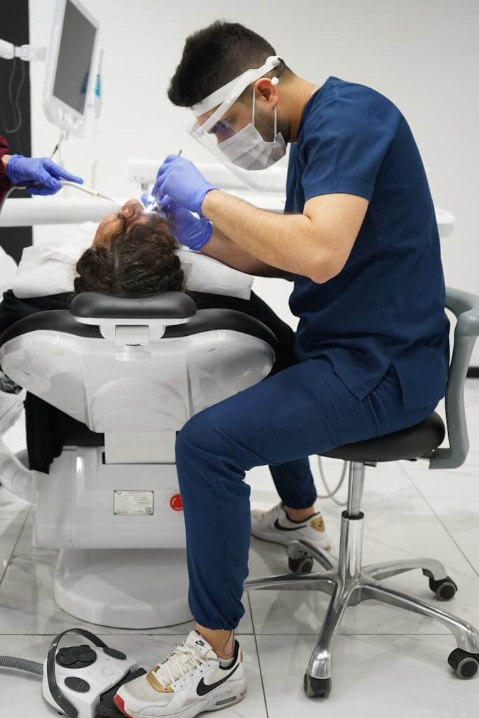 Male Dentist Treating a Patient