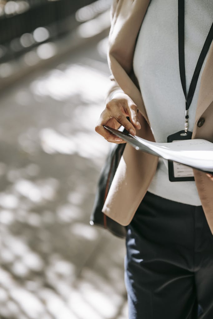 Crop businesswoman with papers in folder